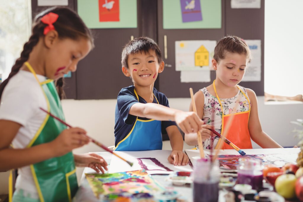 Schoolkids practicing drawing in school